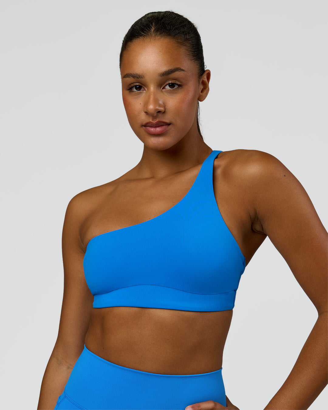 Woman wearing Muse Asymmetric Sports bra - Palace Blue | Model:Rosie | Size:S - view 5