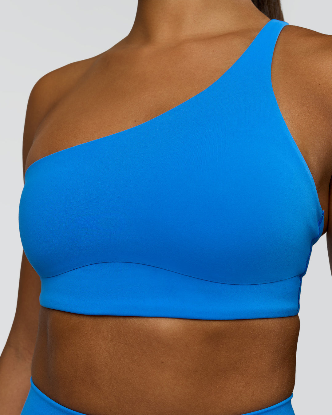 Woman wearing Muse Asymmetric Sports bra - Palace Blue | Model:Rosie | Size:S - view 6