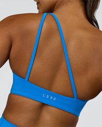 Woman wearing Muse Asymmetric Sports bra - Palace Blue | Model:Rosie | Size:S | Thumbnail Index: 1