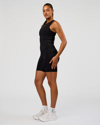 Woman wearing NyxRun Stash Tank - Black | Model:Rosie | Size:S