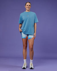 Woman wearing Our Journey Heavyweight Oversized Tee - Azure Blue-Rainbow | Model:Mon | Size:S