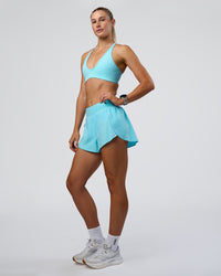 Woman wearing Pacer 3" Run Short - Baltic Sea | Model:Emelia | Size:S
