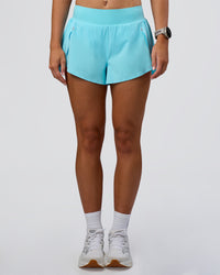 Woman wearing Pacer 3" Run Short - Baltic Sea | Model:Emelia | Size:S