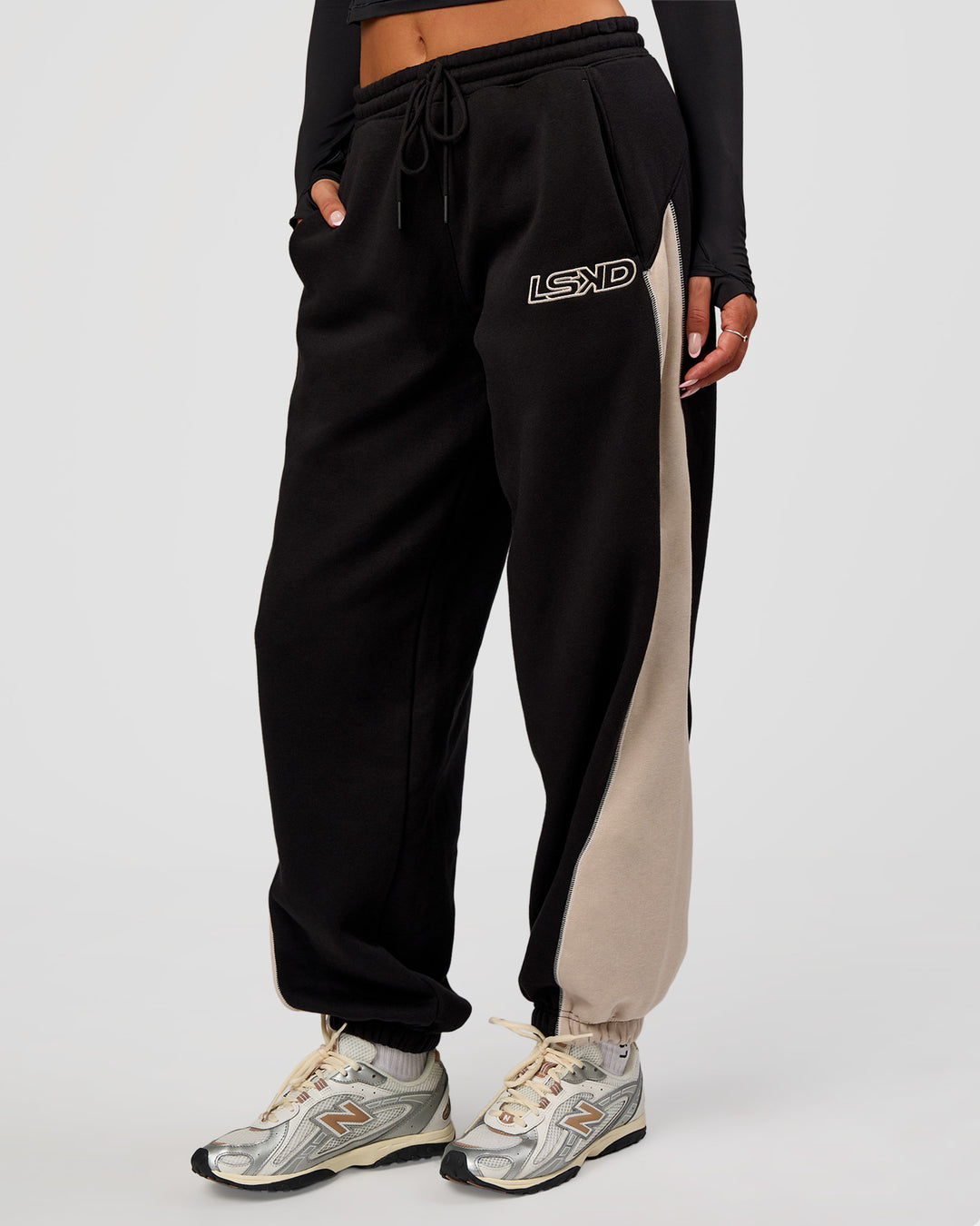 Woman wearing Power Play Stitch Up Fleece Sweat Pant - Black-Shale Beige | Model:Bianca | Size:S