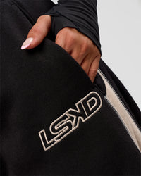 Woman wearing Power Play Stitch Up Fleece Sweat Pant - Black-Shale Beige | Model:Bianca | Size:S