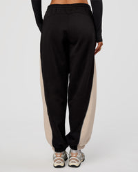 Woman wearing Power Play Stitch Up Fleece Sweat Pant - Black-Shale Beige | Model:Bianca | Size:S
