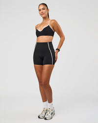 Woman wearing Power Ultra High-Rise 4" Short Pockets - Black | Model:Rhiley | Size:S