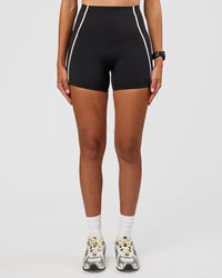 Woman wearing Power Ultra High-Rise 4" Short Pockets - Black | Model:Rhiley | Size:S