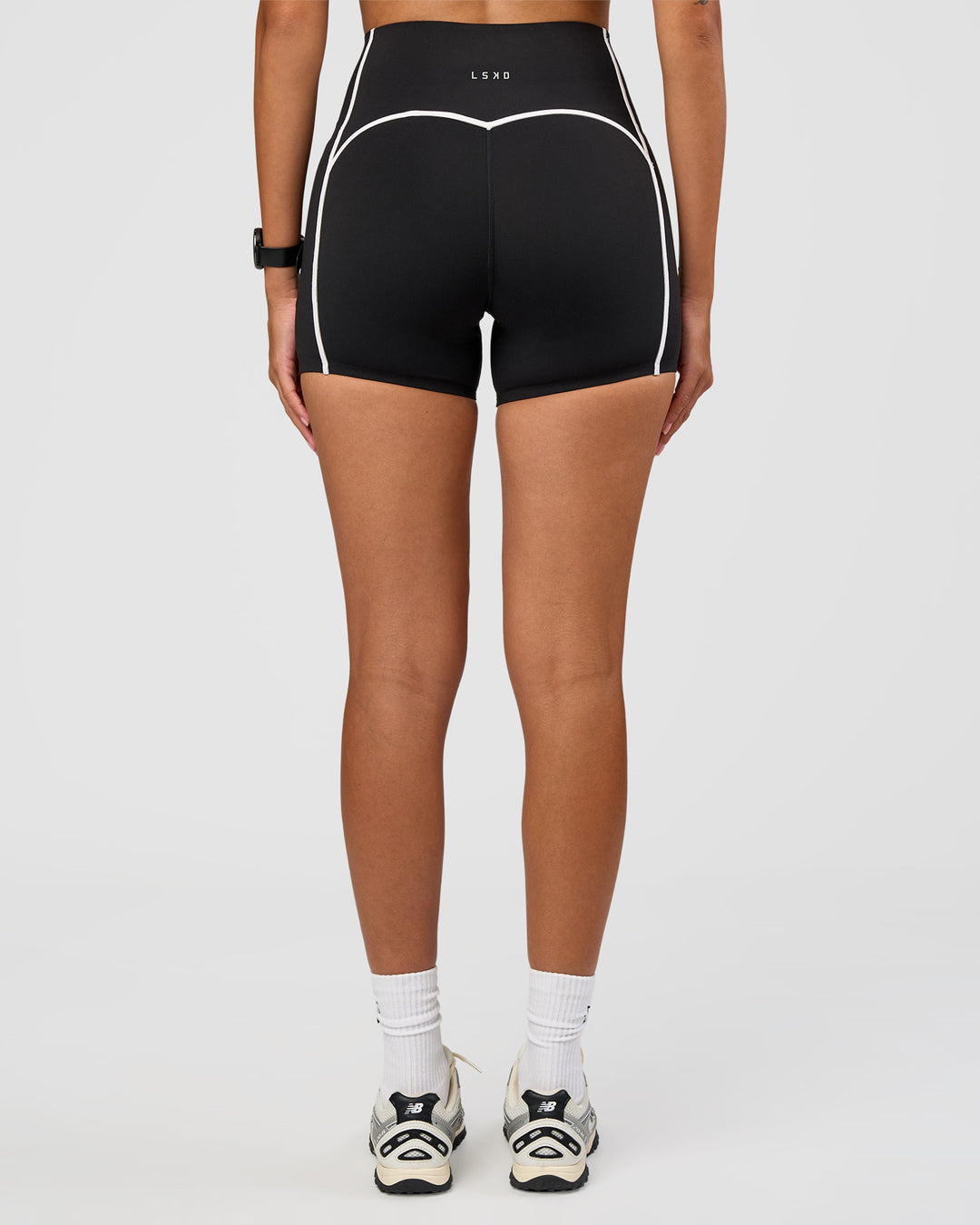 Woman wearing Power Ultra High-Rise 4" Short Pockets - Black | Model:Rhiley | Size:S