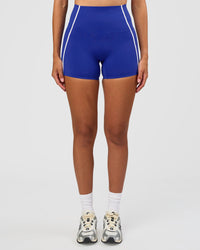Woman wearing Power Ultra High-Rise 4" Short Pockets - Electric Indigo | Model:Rhiley | Size:S