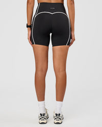 Woman wearing Power Ultra High-Rise 6" Short Pockets - Black | Model:Rhiley | Size:S