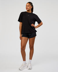 Woman wearing Pride Go-To FLXCotton Oversized Tee - Black | Model:Rosie | Size:S