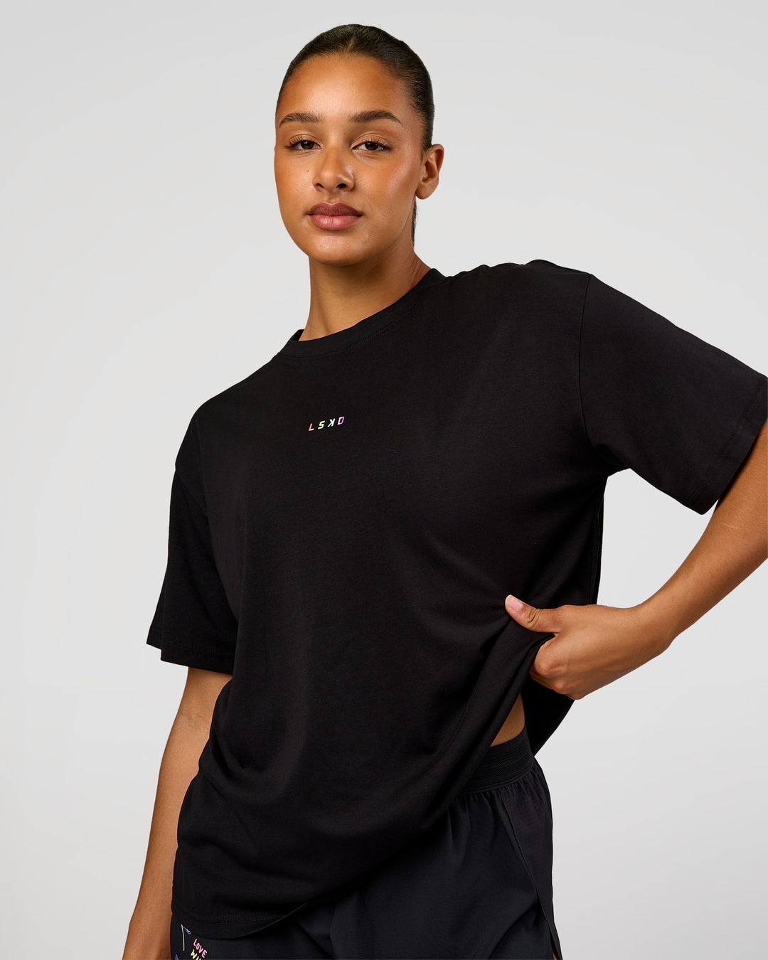 Woman wearing Pride Go-To FLXCotton Oversized Tee - Black | Model:Rosie | Size:S