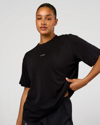 Woman wearing Pride Go-To FLXCotton Oversized Tee - Black | Model:Rosie | Size:S