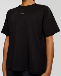 Woman wearing Pride Go-To FLXCotton Oversized Tee - Black | Model:Rosie | Size:S