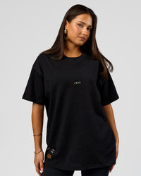 Woman wearing Pride Sticker Boxy Tee - Black | Model:Bianca | Size:S