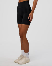 Woman wearing Progression Ultra High-Rise 6" Short - Black | Model:Kirstyn | Size:S