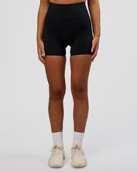 Woman wearing Progression Ultra High-Rise 4" Short - Black | Model:Kirstyn | Size:S