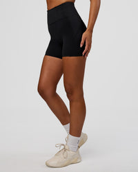 Woman wearing Progression Ultra High-Rise 4" Short - Black | Model:Kirstyn | Size:S