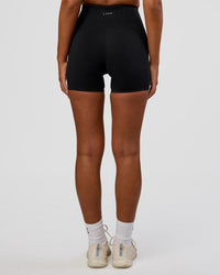 Woman wearing Progression Ultra High-Rise 4" Short - Black | Model:Kirstyn | Size:S