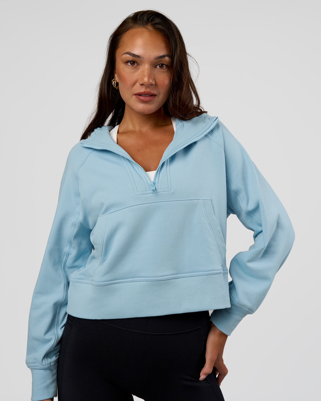 Woman wearing Pursue Mid-Weight Hoodie - Glacial Blue | Model:Kirstyn | Size:S