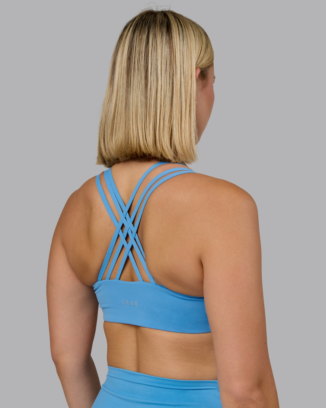 Woman wearing Push The Limit Sports Bra - Azure Blue | Model:Halle | Size:S