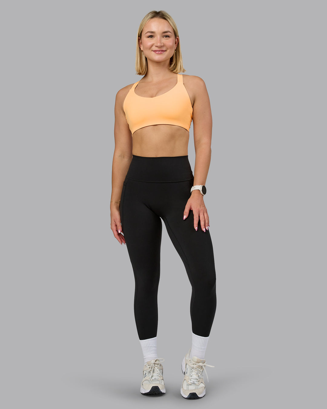 Woman wearing Push The Limit Sports Bra - Peach Fuzz | Model:Halle | Size:S