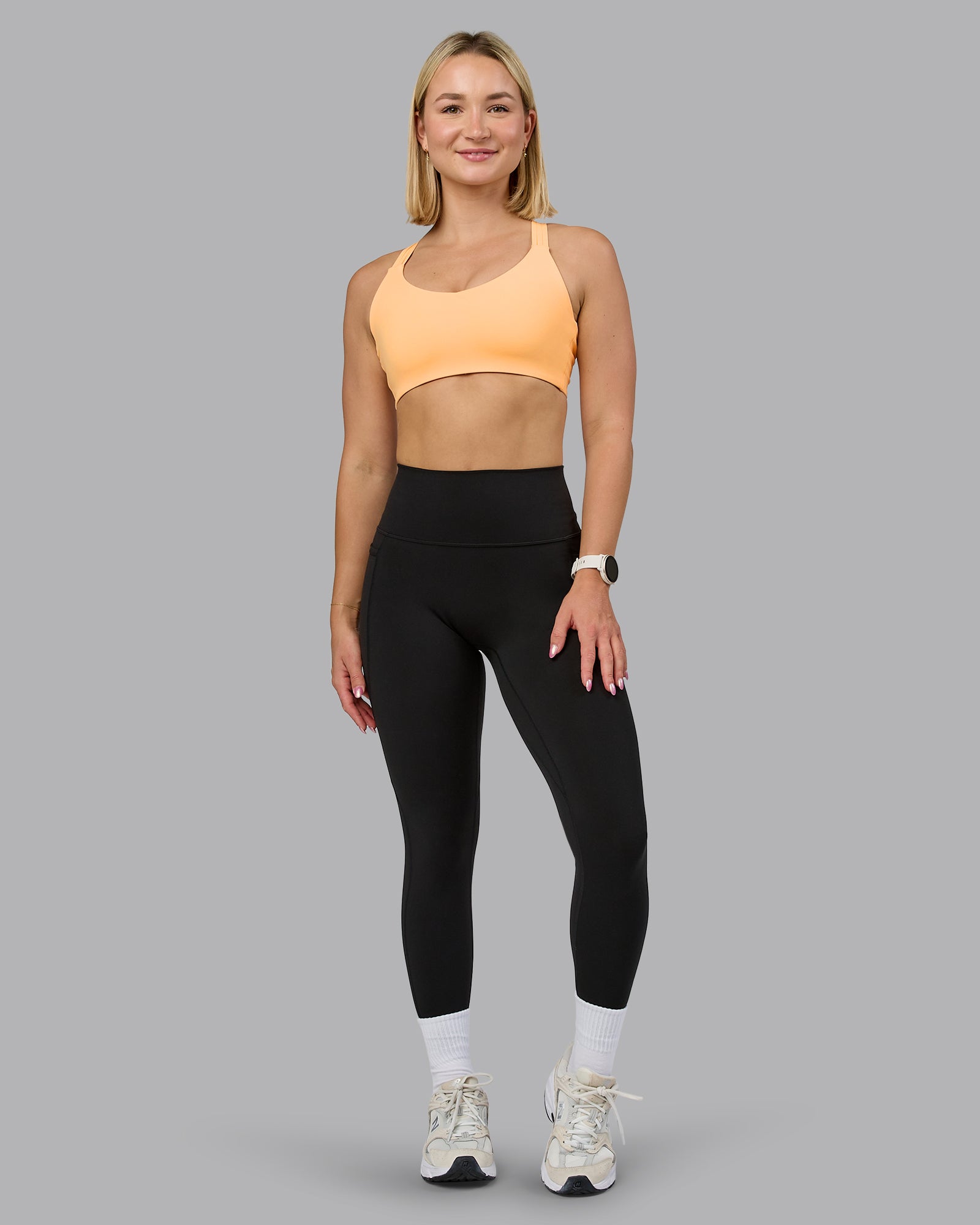 Woman wearing Push The Limit Sports Bra - Peach Fuzz | Model:Halle | Size:S
