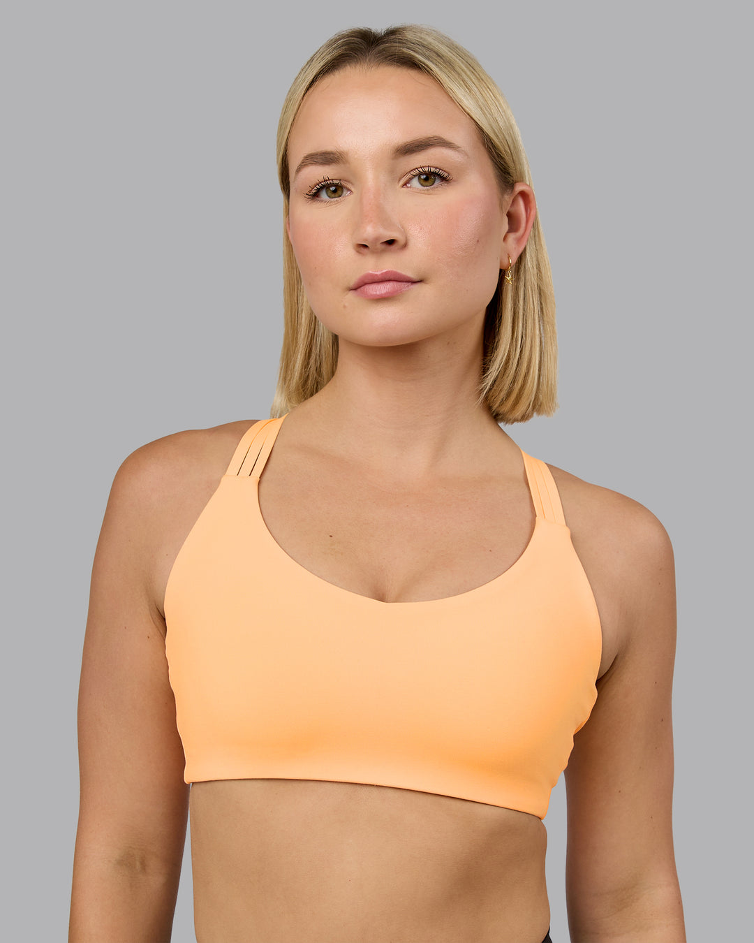 Woman wearing Push The Limit Sports Bra - Peach Fuzz | Model:Halle | Size:S