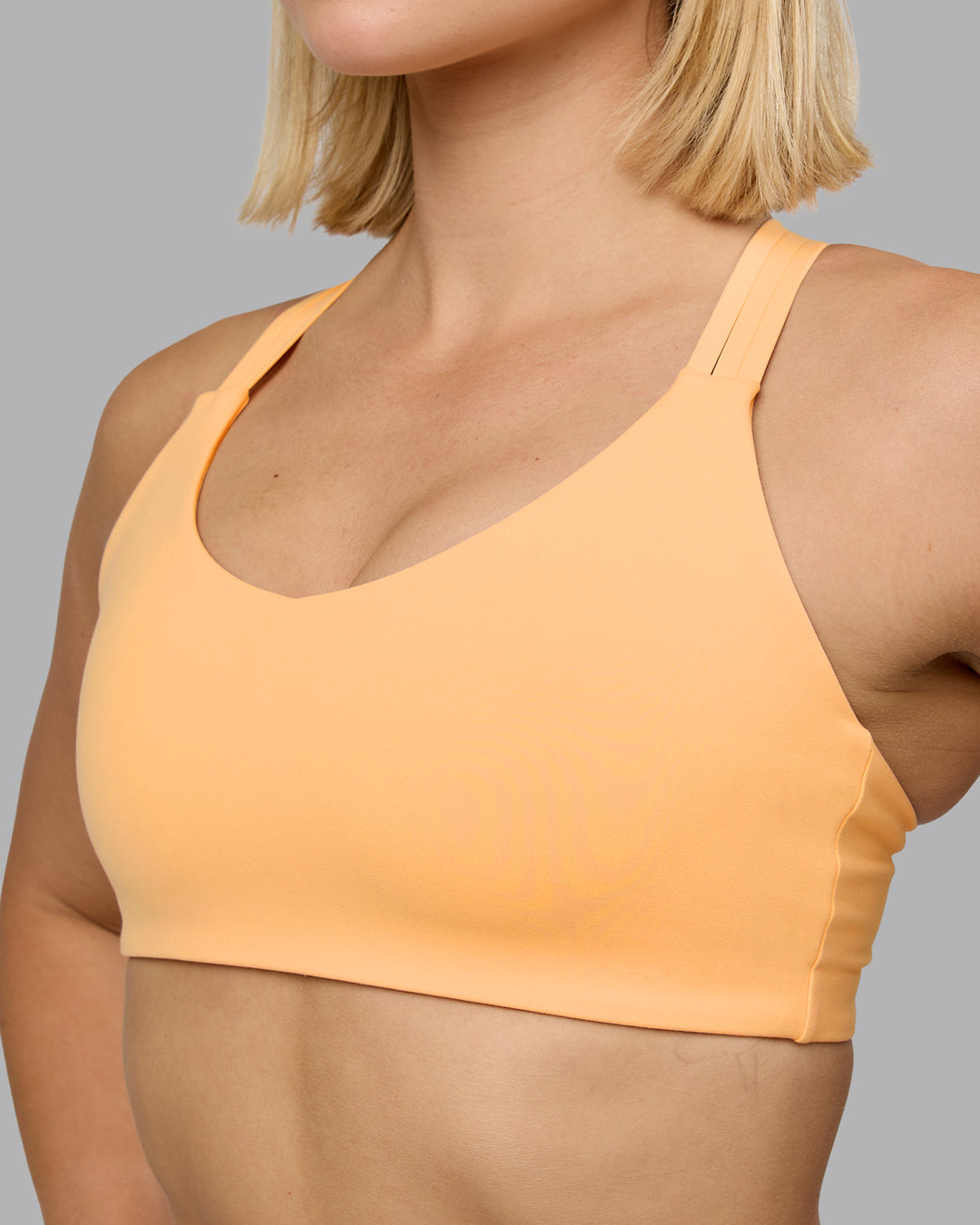 Woman wearing Push The Limit Sports Bra - Peach Fuzz | Model:Halle | Size:S