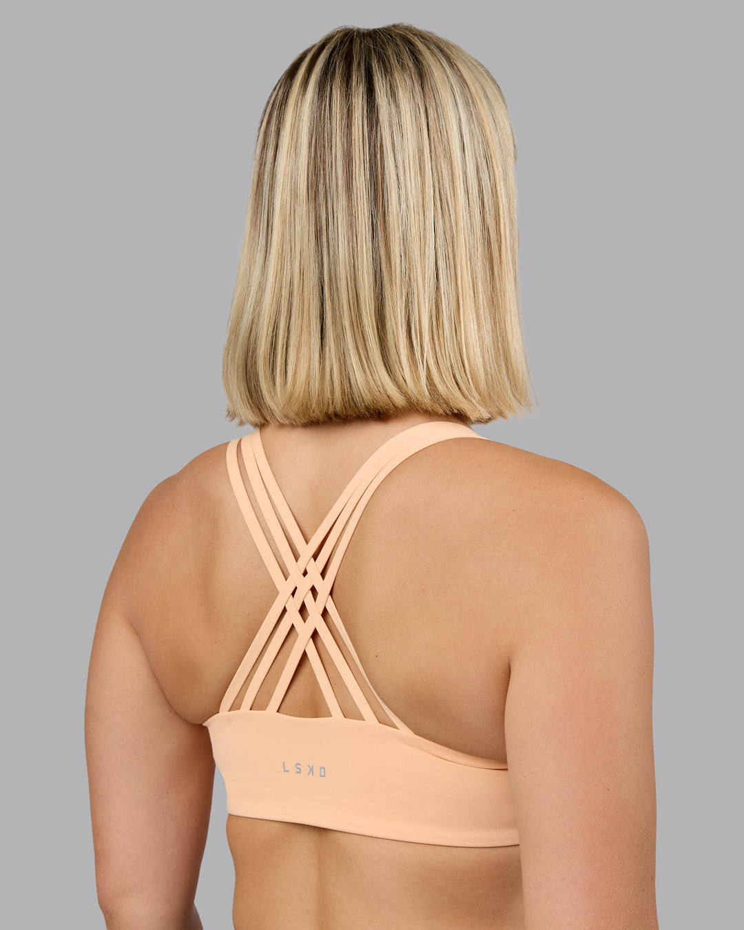 Woman wearing Push The Limit Sports Bra - Peach Fuzz | Model:Halle | Size:S
