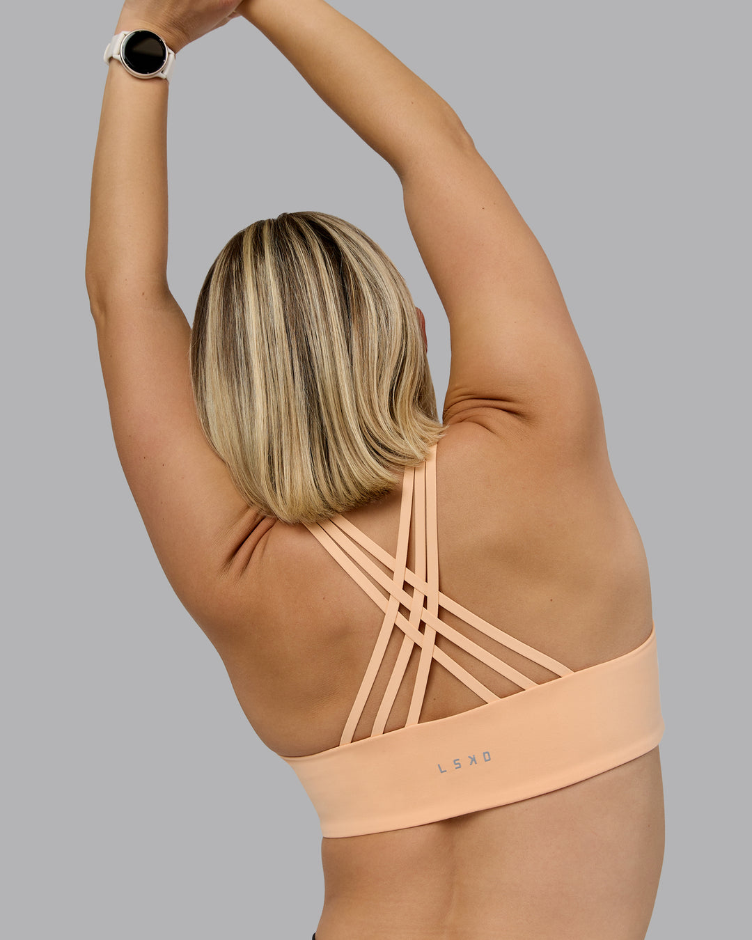 Woman wearing Push The Limit Sports Bra - Peach Fuzz | Model:Halle | Size:S