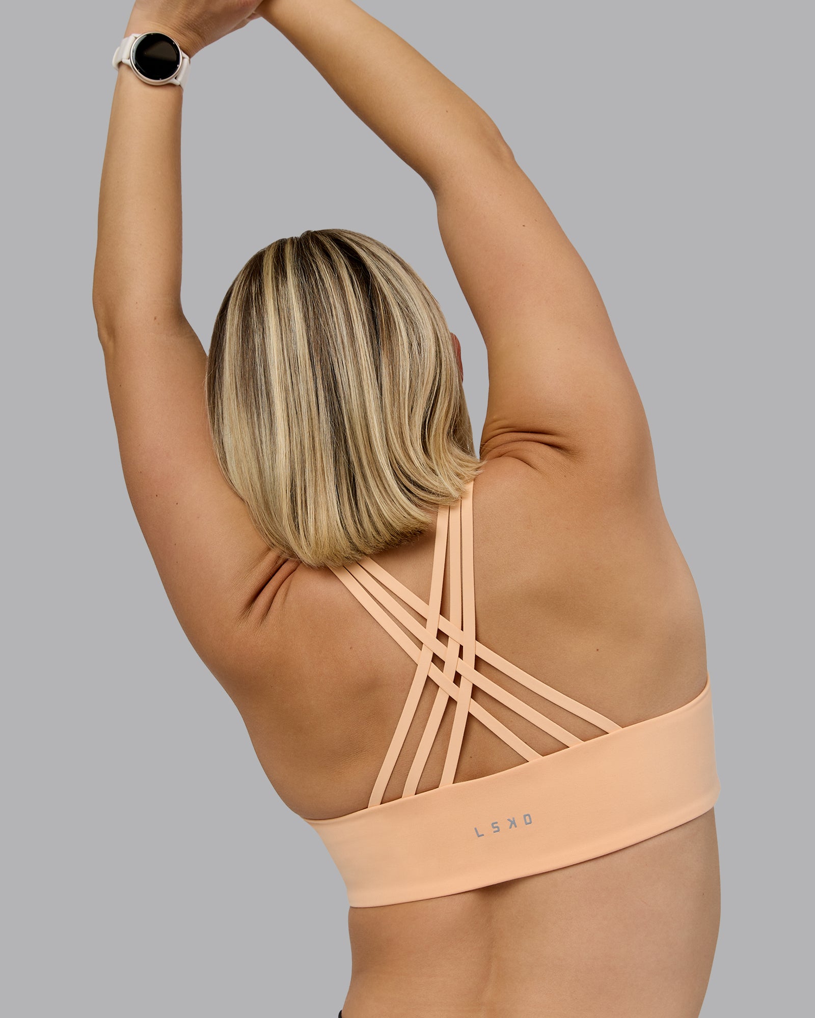 Woman wearing Push The Limit Sports Bra - Peach Fuzz | Model:Halle | Size:S