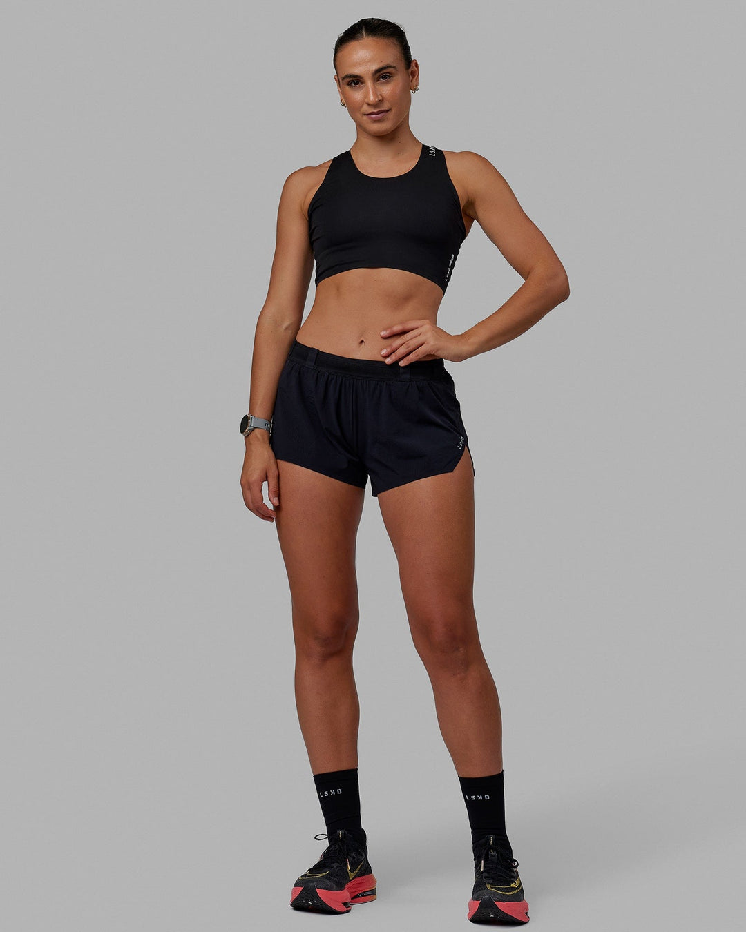 Woman wearing Race Day Cropped Performance Tank - Black-White