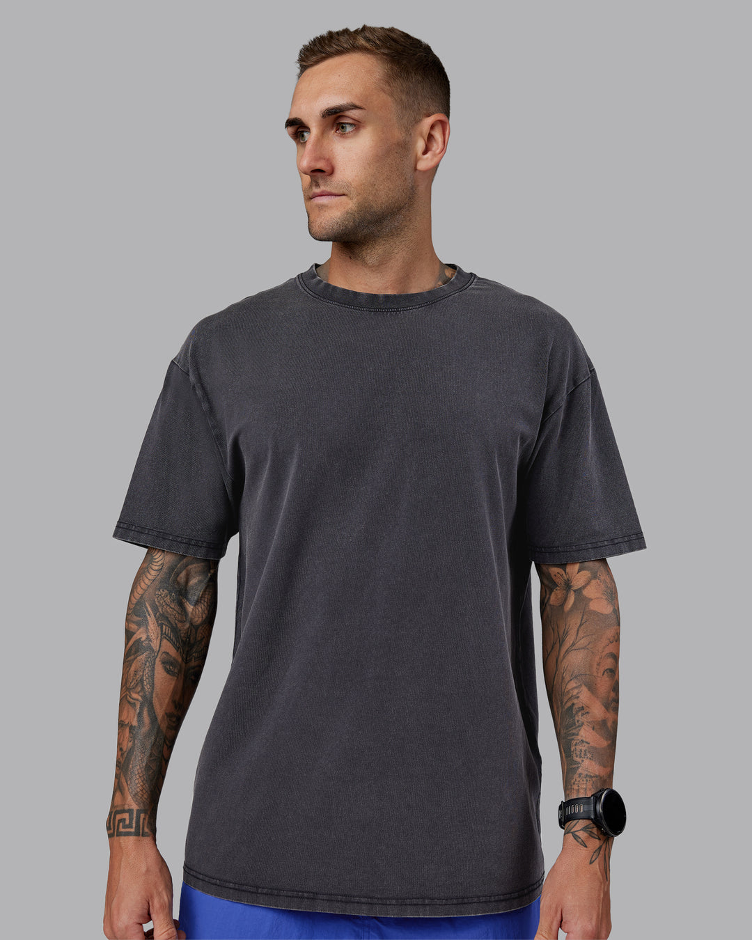 Man wearing Relentless Washed FLXCotton Oversized Tee - Black-Ultimate Grey | Model:Tommy | Size:S
