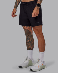 Man wearing Rep 5" Lined Performance Shorts in Black | Size:S
