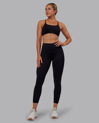 Woman wearing Rep Ultra High-Rise 7/8 Legging Pockets - Black-Retro Blue | Model:Paris | Size:S