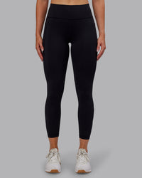 Woman wearing Rep Ultra High-Rise 7/8 Legging Pockets - Black-Retro Blue | Model:Paris | Size:S