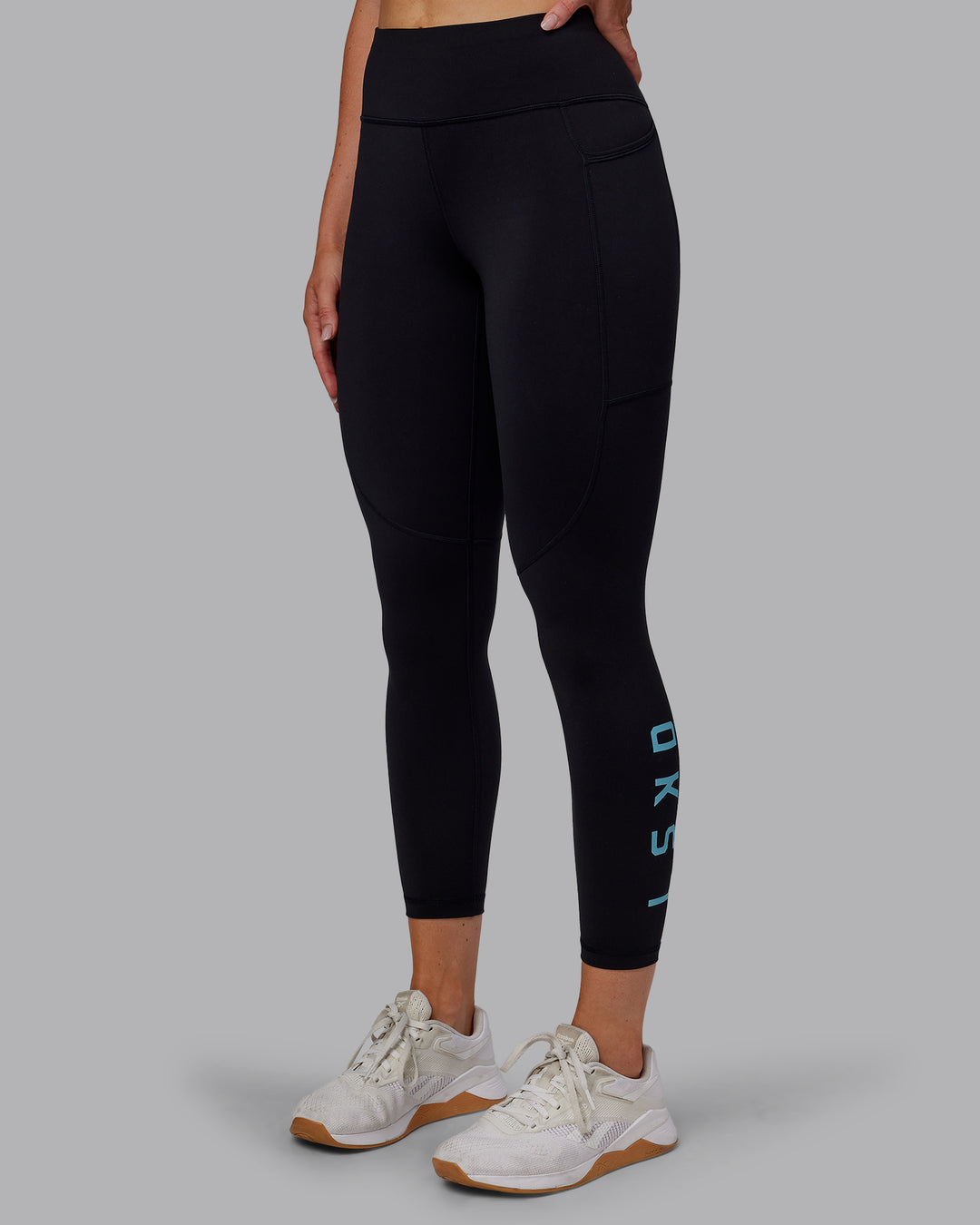 Woman wearing Rep Ultra High-Rise 7/8 Legging Pockets - Black-Retro Blue | Model:Paris | Size:S