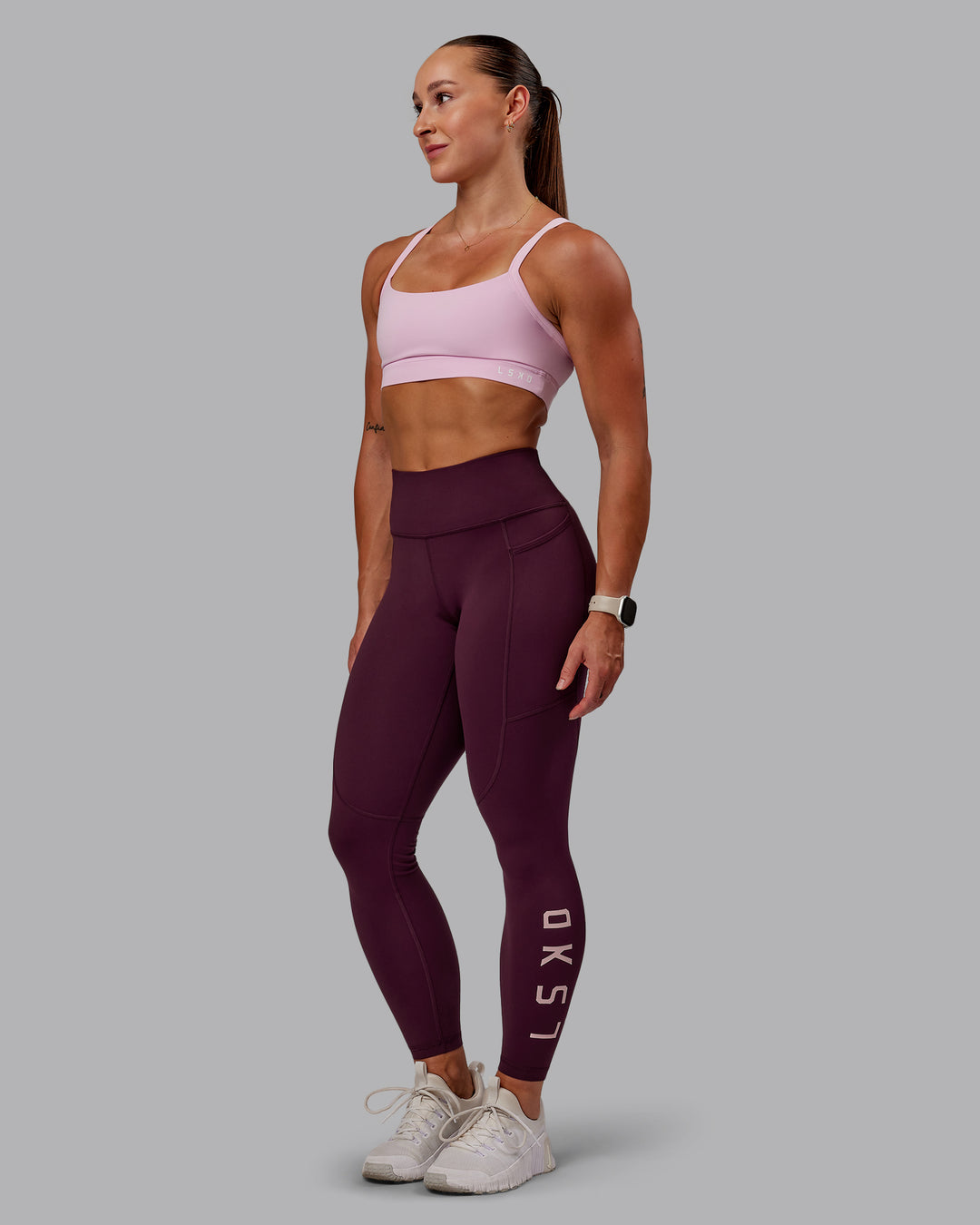 Woman wearing Rep Ultra High-Rise 7/8 Legging Pockets - Cherry Lacquer-Marshmallow | Model:Amber | Size:S