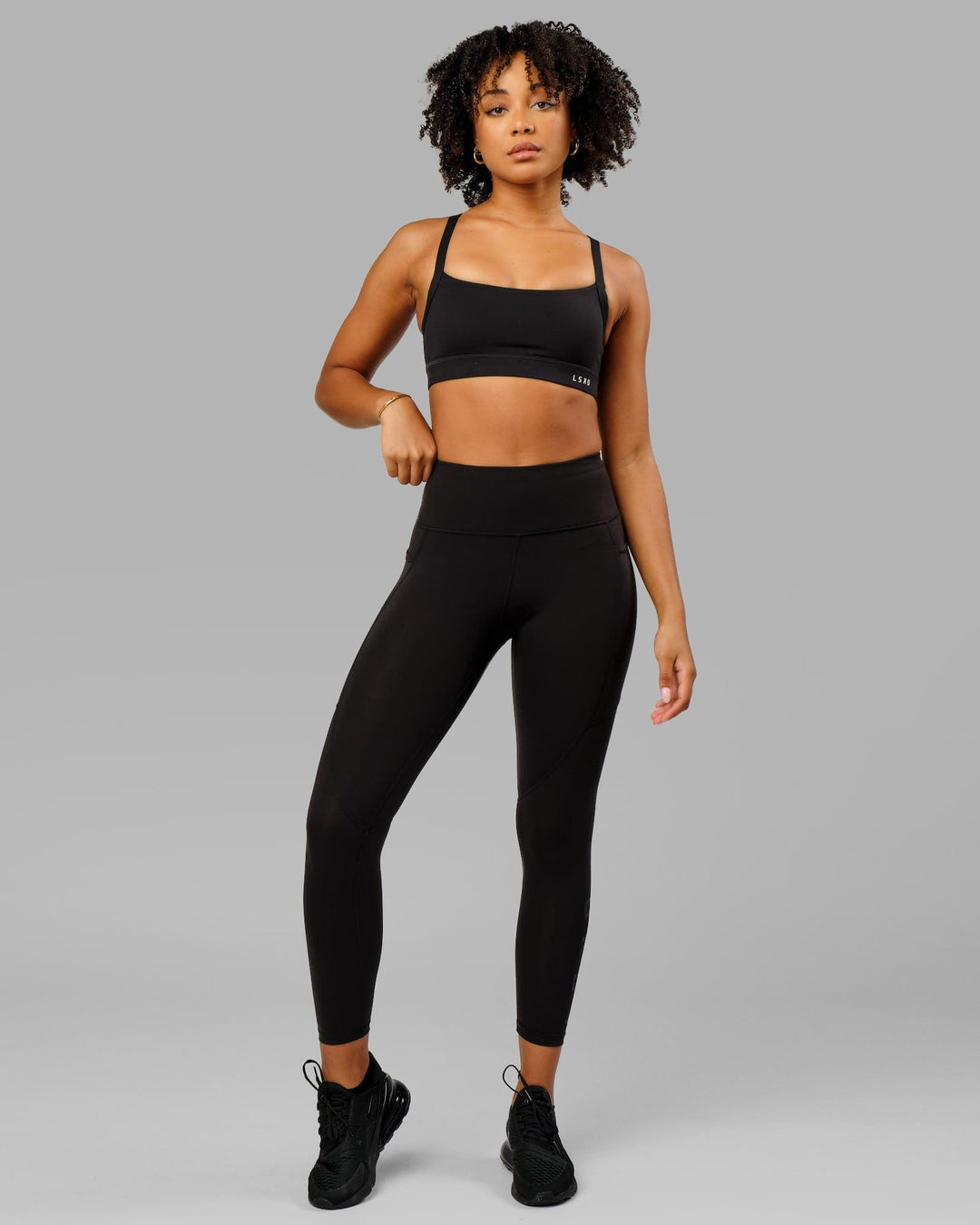 Woman wearing Rep Ultra High-Rise 7/8 Legging Pockets - Black-Black | Model:Isabella | Size:S
