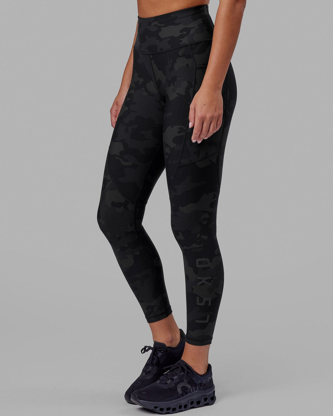 Woman wearing Rep Ultra High-Rise 7/8 Legging Pockets - Black Camo | Model:Milly | Size:S
