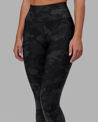 Woman wearing Rep Ultra High-Rise 7/8 Legging Pockets - Black Camo | Model:Milly | Size:S