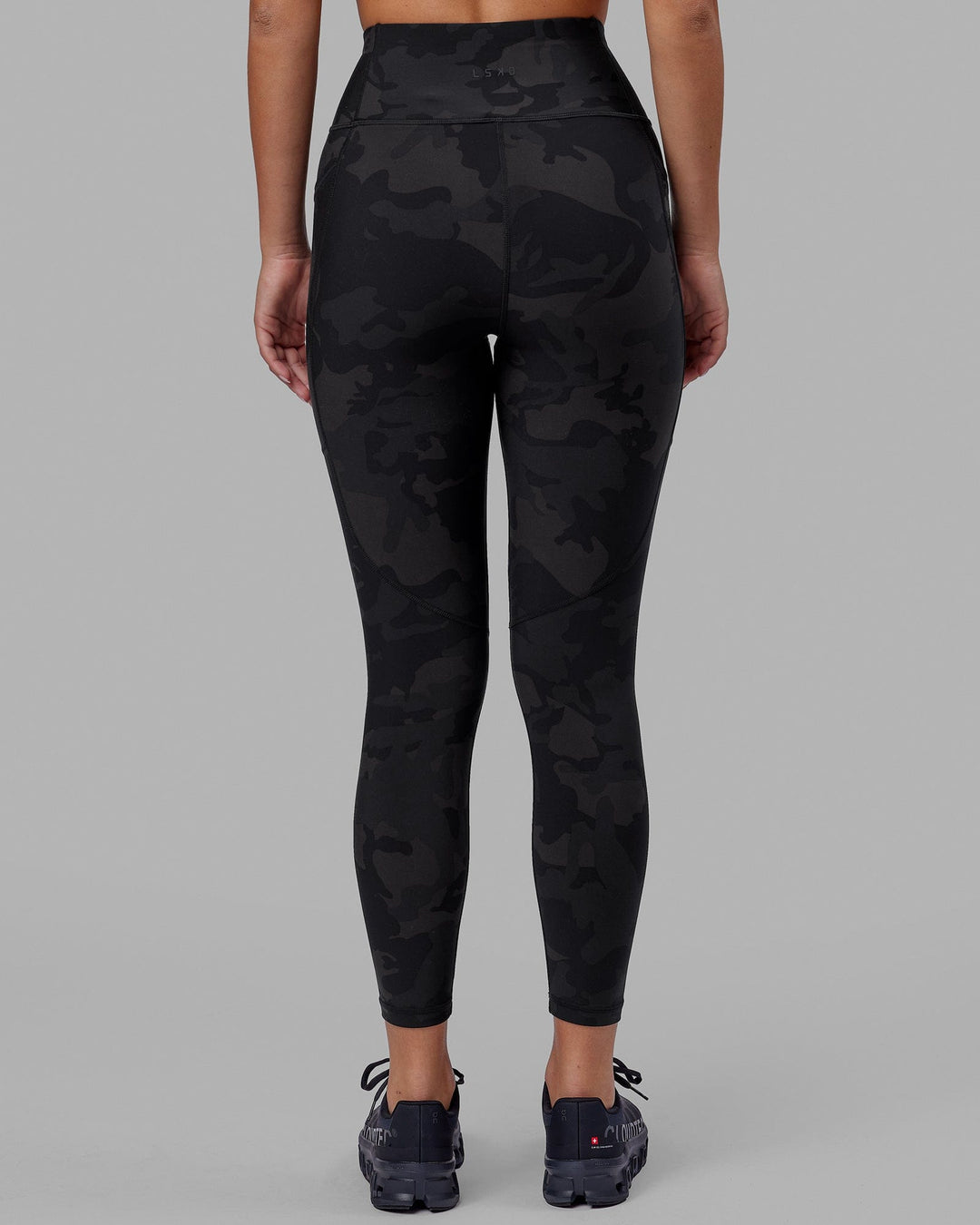 Woman wearing Rep Ultra High-Rise 7/8 Legging Pockets - Black Camo | Model:Milly | Size:S