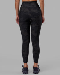 Woman wearing Rep Ultra High-Rise 7/8 Legging Pockets - Black Camo | Model:Milly | Size:S