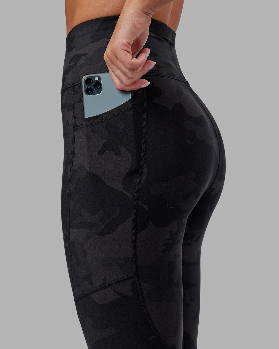 Woman wearing Rep Ultra High-Rise 7/8 Legging Pockets - Black Camo | Model:Milly | Size:S
