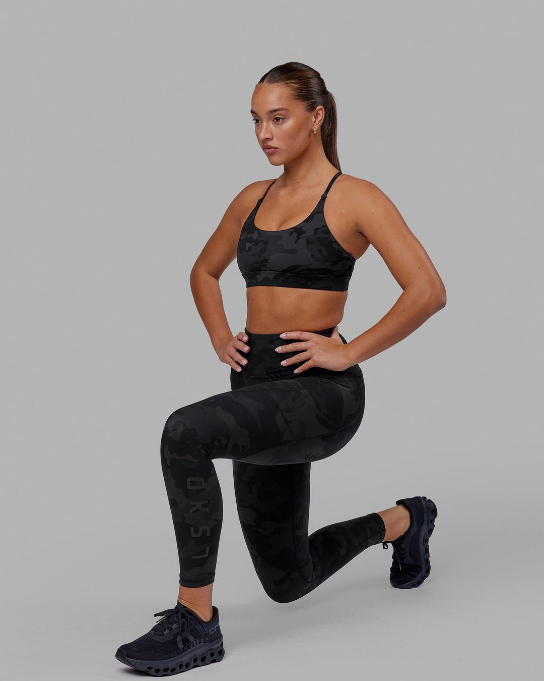 Woman wearing Rep Ultra High-Rise 7/8 Legging Pockets - Black Camo | Model:Milly | Size:S