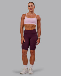 Woman wearing Rep Ultra High-Rise 9" Short Pockets - Cherry Lacquer-Marshmallow | Model:Amber | Size:S