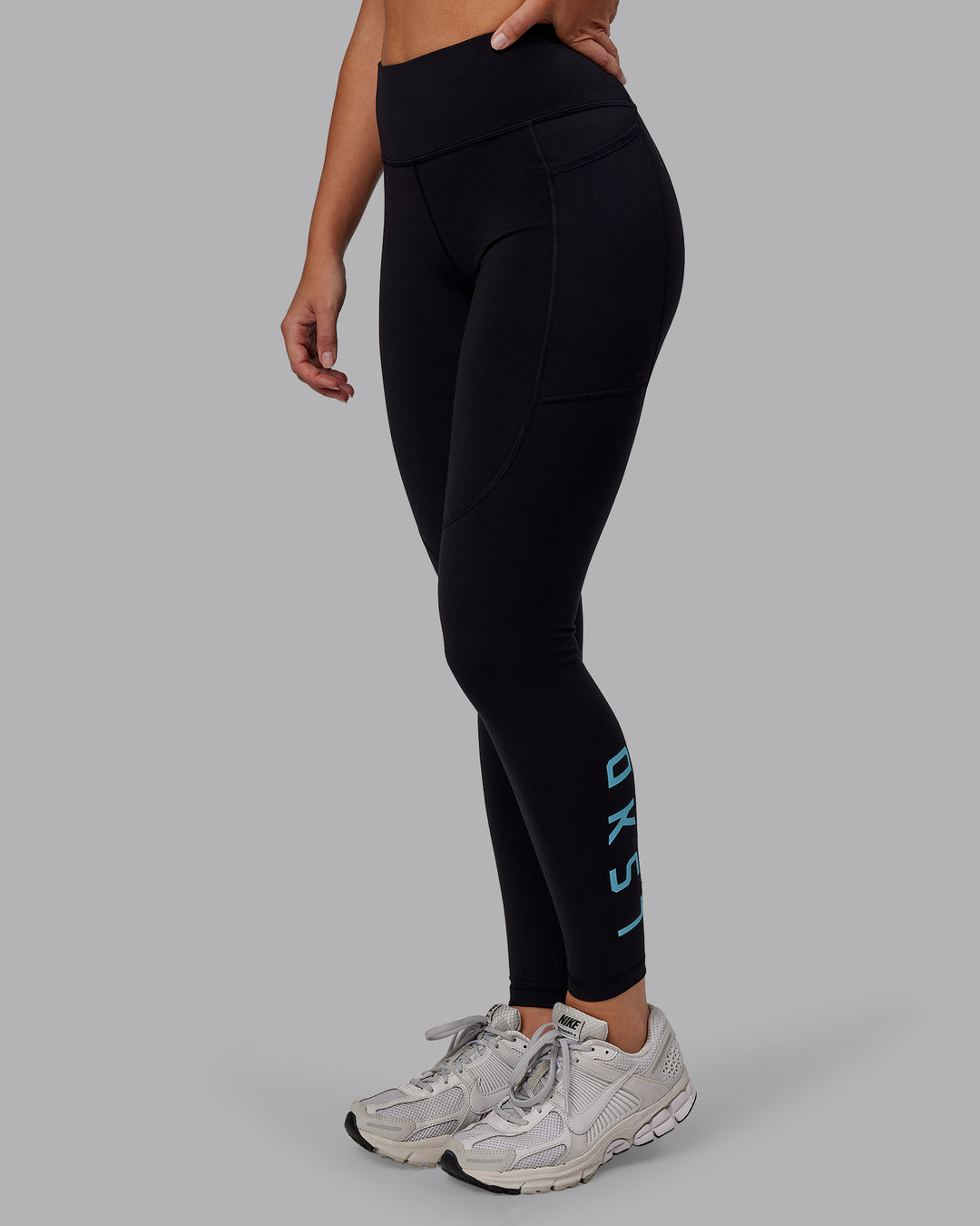 Woman wearing Rep Ultra High-Rise Full Length Legging Pockets - Black-Retro Blue | Model:Hannah | Size:S