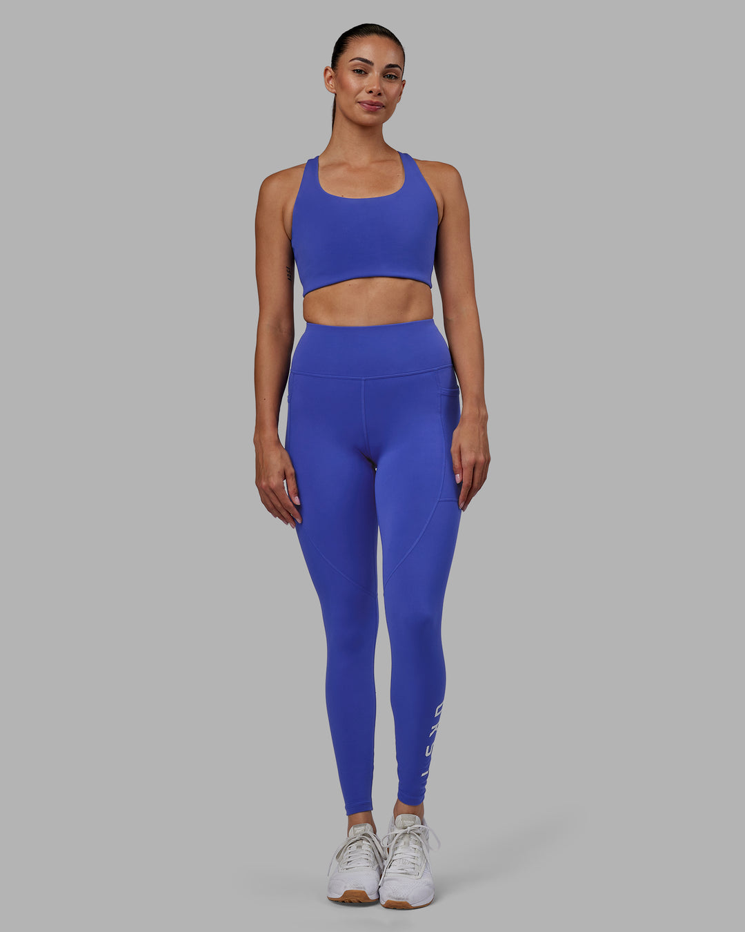 Woman wearing Rep Ultra High-Rise Full Length Legging Pockets - Power Cobalt-White | Model:Blaize | Size:S